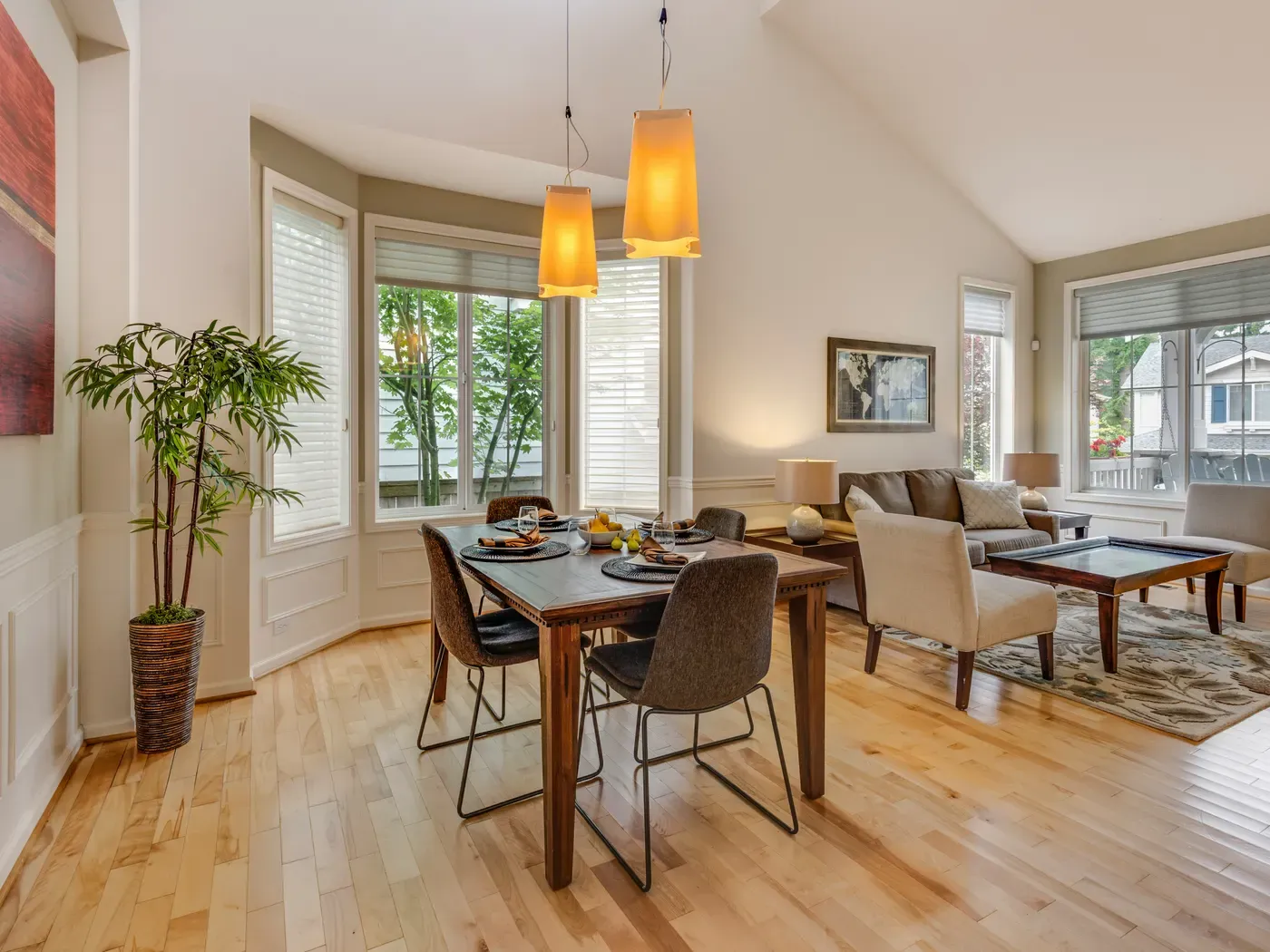 A bright, freshly cleaned dining and living room with hardwood floors